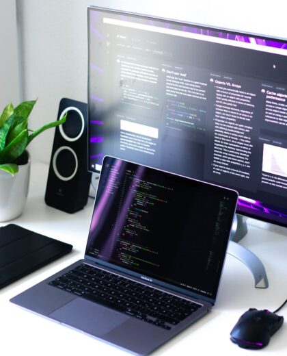 Photo by Walling black and silver laptop computer beside black computer mouse